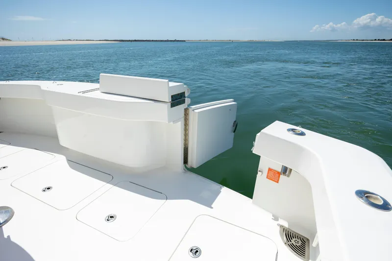 Slide: The Image of 2013 Viking 42 yacht deck with open transom door, overlooking calm ocean waters. - 21