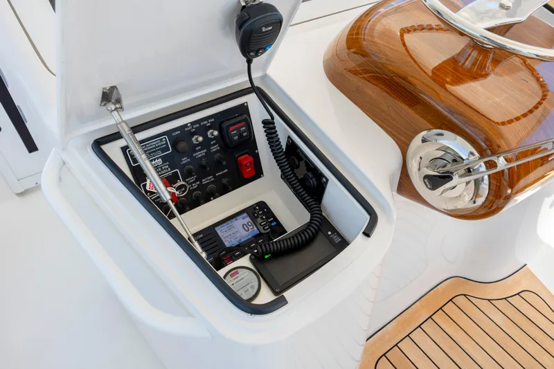 Slide: The Image of Control panel of a 2013 Viking 42 yacht with communication equipment and wooden accents. - 26