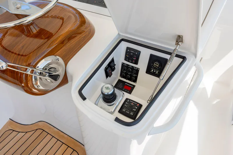 Slide: The Image of Control panel of a 2013 Viking 42 yacht with joystick and navigation instruments. - 27