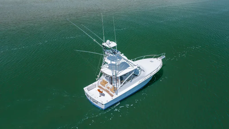 Slide: The Image of Aerial view of 2013 Viking 42 boat on calm green water. - 3