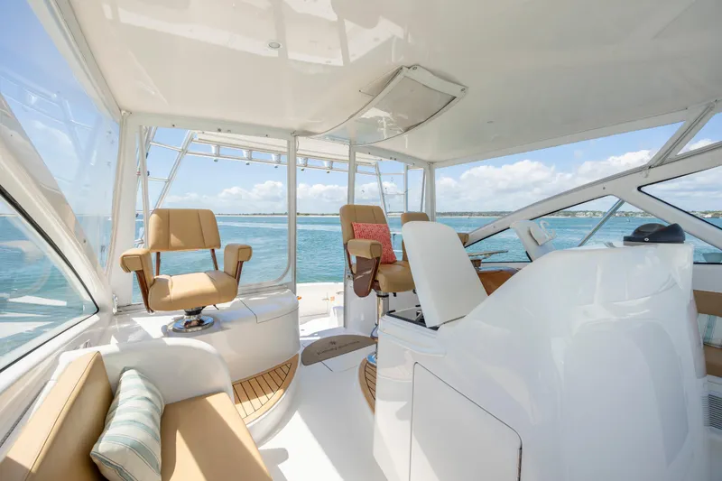 Slide: The Image of Luxurious 2013 Viking 42 yacht interior with ocean view, featuring comfortable seating and modern design. - 33