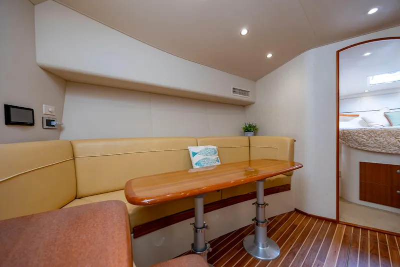 Slide: The Image of Interior of 2013 Viking 42 yacht with beige seating and wooden table. - 38