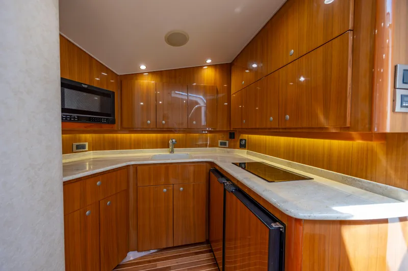 Slide: The Image of Luxurious wooden kitchen interior of 2013 Viking 42 yacht, featuring modern appliances and sleek countertops. - 40