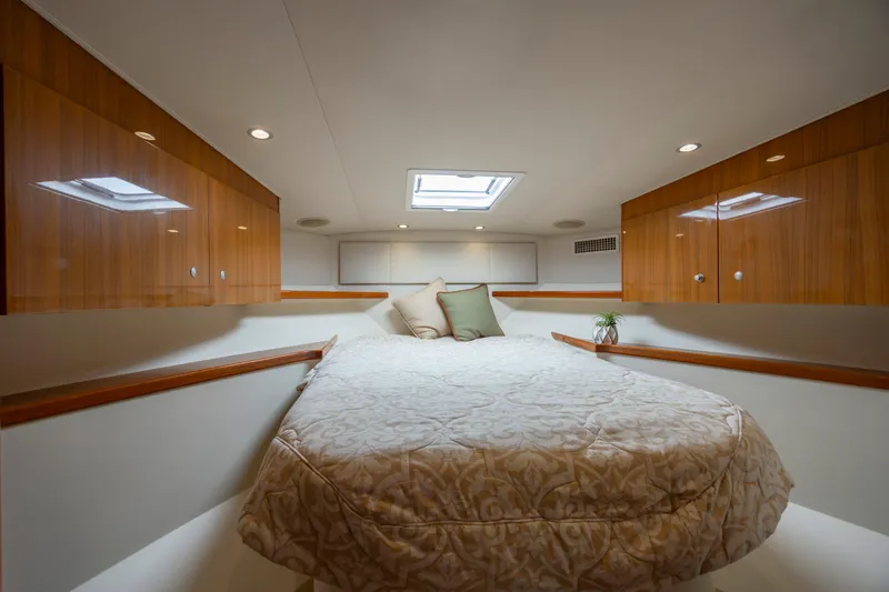 Slide: The Image of Luxurious cabin interior of 2013 Viking 42 yacht with cozy bed and wooden accents. - 43