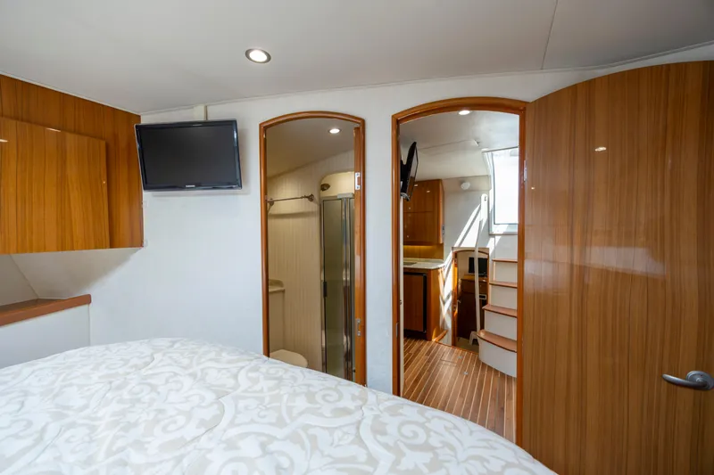 Slide: The Image of Interior of 2013 Viking 42 yacht with wood finishes, TV, and stairs. - 45