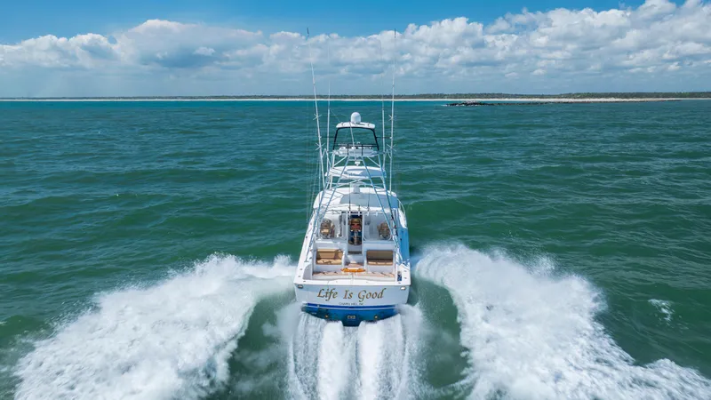 Slide: The Image of Viking 42 yacht cruising on open sea, 2013 model, with "Life is Good" on the stern. - 9