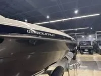 Slide: The Image of 2016 Scarab 255 H.O. Platinum boat displayed in a showroom setting. - 10