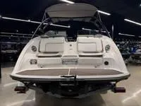 Slide: The Image of 2016 Scarab 255 H.O. Platinum boat, rear view in showroom, sleek design, white exterior. - 12