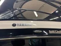 Slide: The Image of 2016 Scarab 255 H.O. Platinum boat with Yamaha branding, indoor setting. - 7