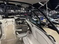 Slide: The Image of Interior of 2016 Scarab 255 H.O. Platinum boat in showroom, featuring sleek design and modern controls. - 9