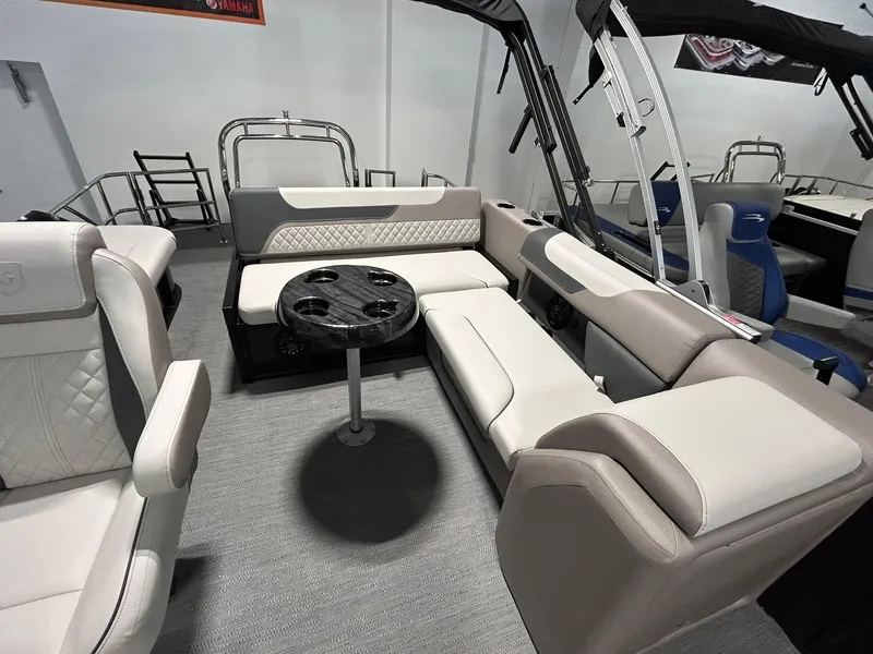 Slide: The Image of 2025 Godfrey SWEETWATER 2286 SFL pontoon boat interior with plush seating and table. - 11