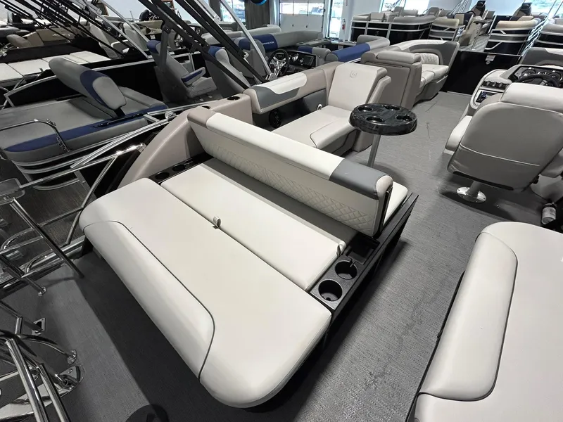 Slide: The Image of 2025 Godfrey SWEETWATER 2286 SFL boat interior with plush seating and cup holders. - 12