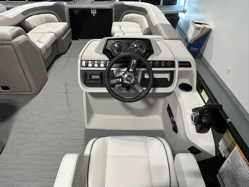 Slide: The Image of 2025 Godfrey SWEETWATER 2286 SFL boat interior with modern steering console and seating. - 9