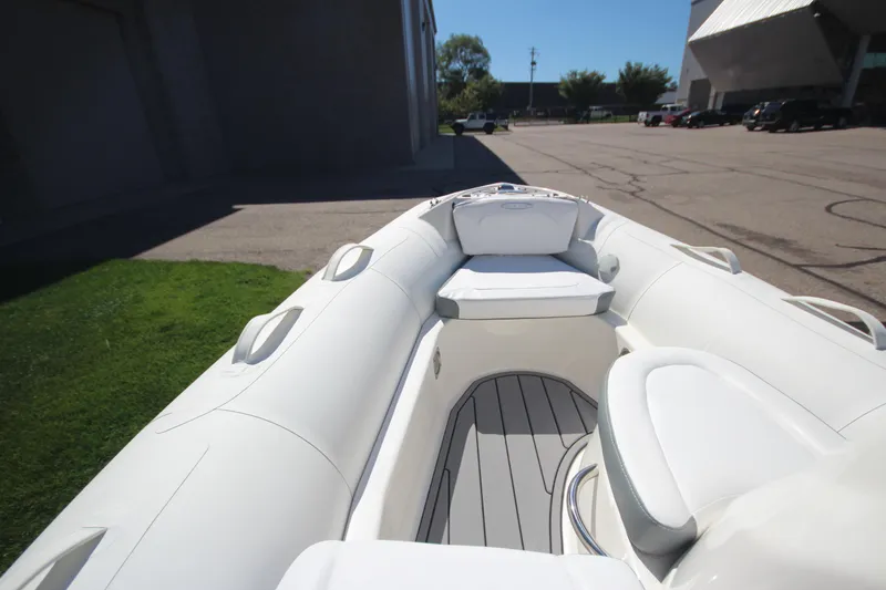 Slide: The Image of 2025 Zodiac Yachtline 400 DL NEO 50hp boat, white interior, docked outdoors. - 13