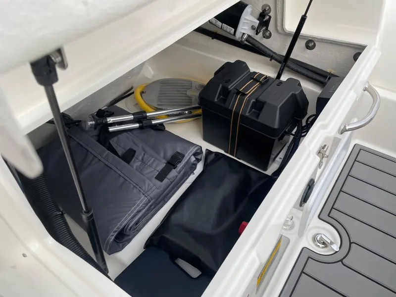 Slide: The Image of Storage compartment of 2025 Zodiac Yachtline 490 Deluxe NEO 90hp, featuring boating accessories. - 24