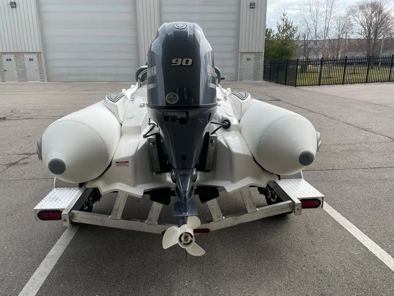 Slide: The Image of 2025 Zodiac Yachtline 490 Deluxe NEO with 90hp engine on trailer, rear view. - 8