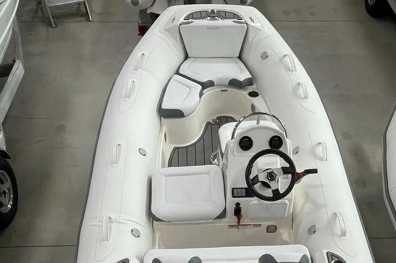 Slide: The Image of 2025 Zodiac Yachtline 490 Deluxe NEO, 90hp, sleek white design, spacious seating, in stock. - 36