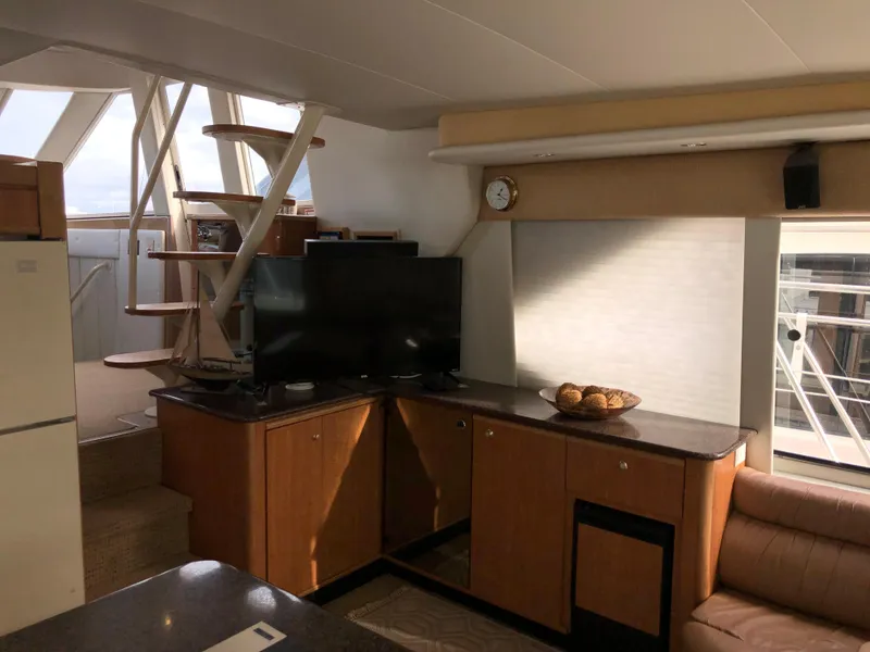 Slide: The Image of Interior of 2002 Bayliner 5288 PILOTHOUSE with modern furnishings and spiral staircase. - 10
