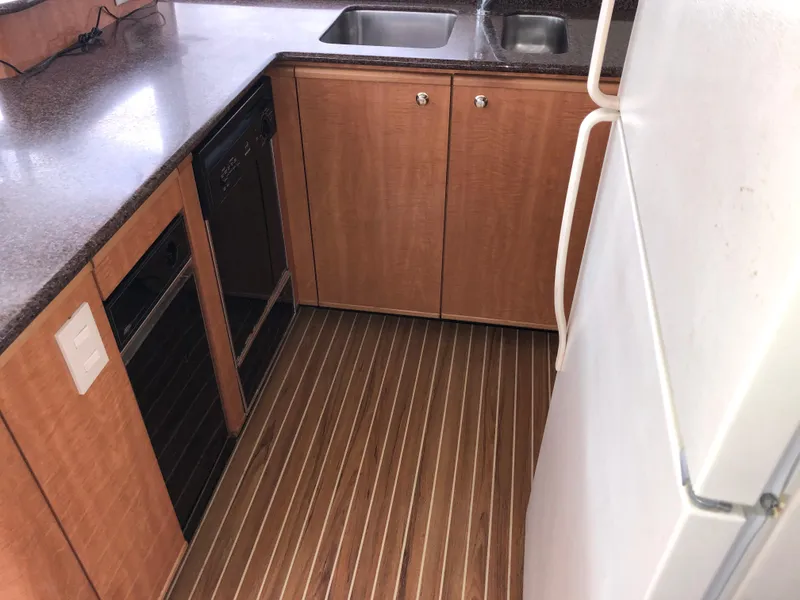 Slide: The Image of 2002 Bayliner 5288 PILOTHOUSE kitchen with wood cabinets and dual sinks. - 14