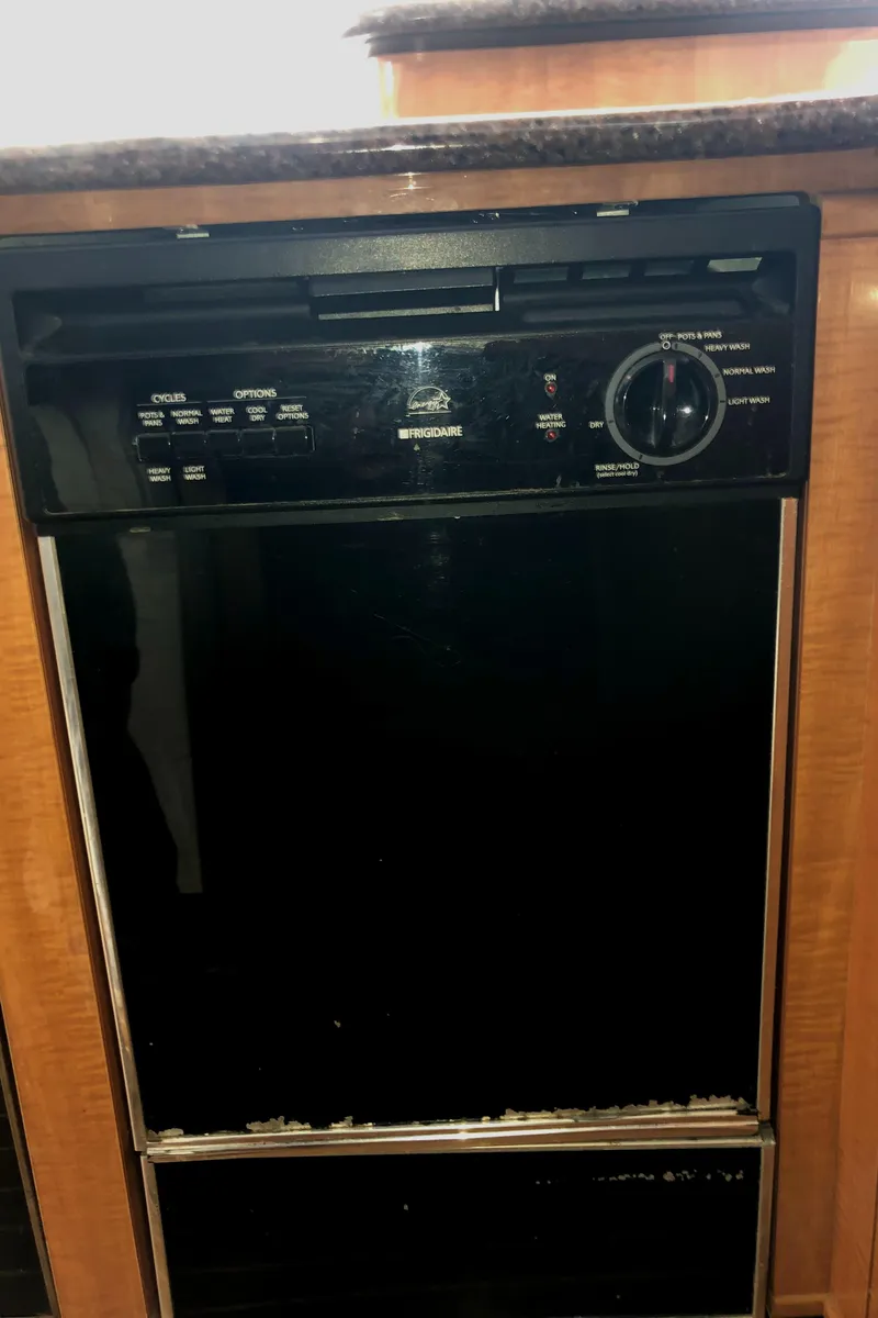 Slide: The Image of 2002 Bayliner 5288 PILOTHOUSE dishwasher, black finish, integrated in wooden cabinetry. - 15