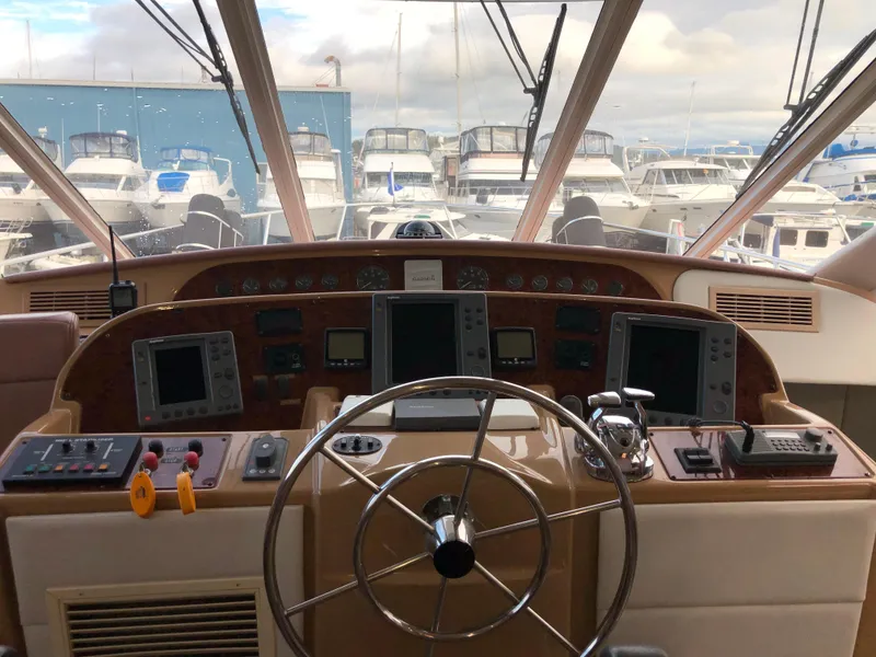 Slide: The Image of Pilothouse interior of 2002 Bayliner 5288, featuring navigation controls and steering wheel. - 20