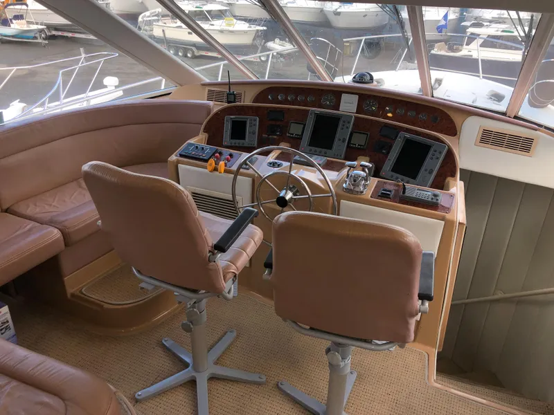 Slide: The Image of 2002 Bayliner 5288 PILOTHOUSE helm with dual seats and navigation equipment. - 22