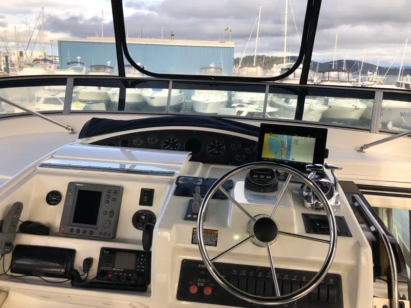 Slide: The Image of Pilothouse of 2002 Bayliner 5288 with navigation equipment and steering wheel, docked at marina. - 26