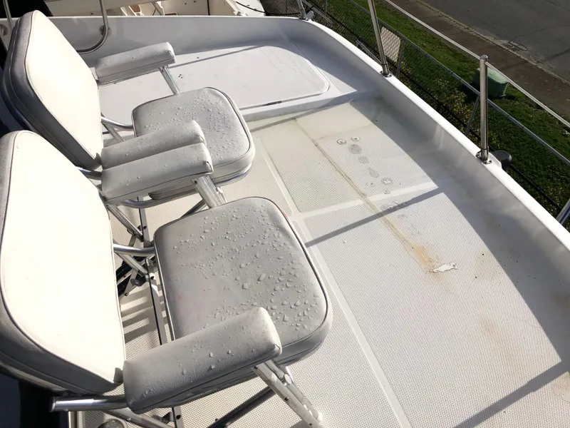 Slide: The Image of Deck of 2002 Bayliner 5288 PILOTHOUSE with wet chairs and railing. - 30