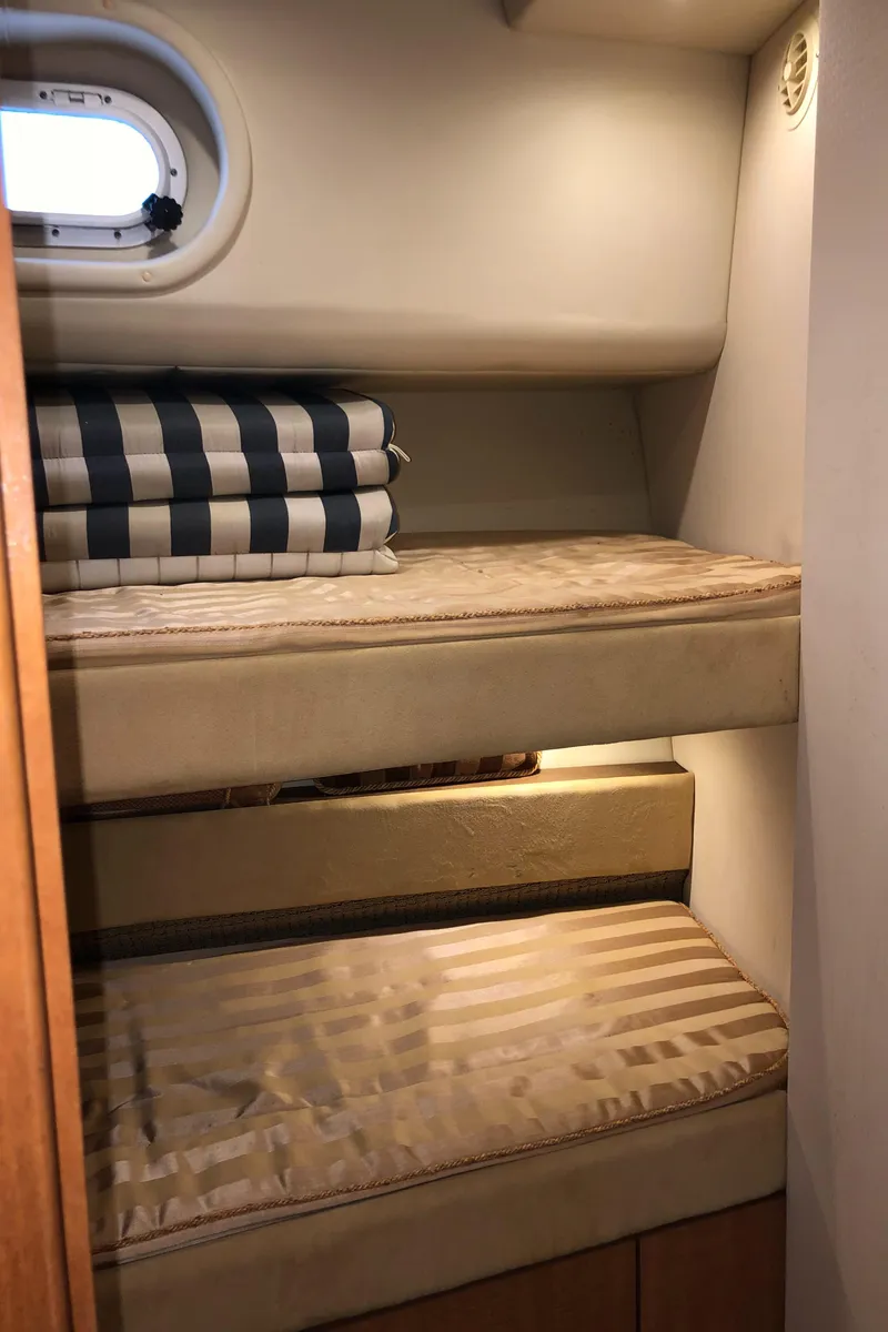 Slide: The Image of 2002 Bayliner 5288 PILOTHOUSE cabin with cozy bunk beds and striped bedding. - 37
