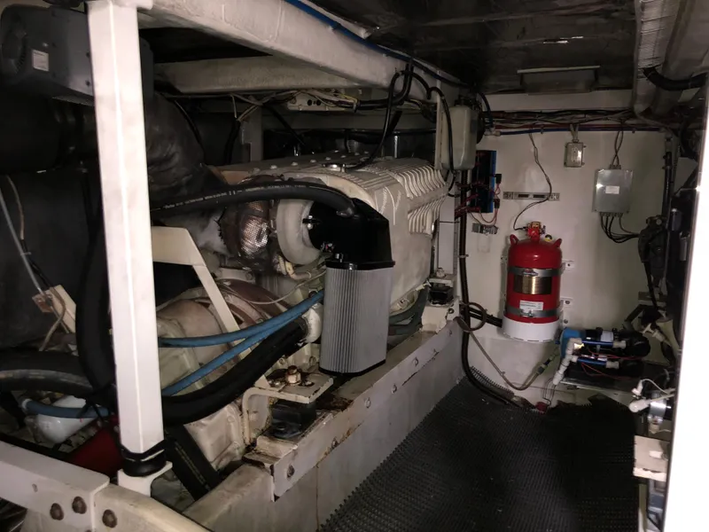 Slide: The Image of Engine room of 2002 Bayliner 5288 PILOTHOUSE with visible machinery and fire extinguisher. - 48