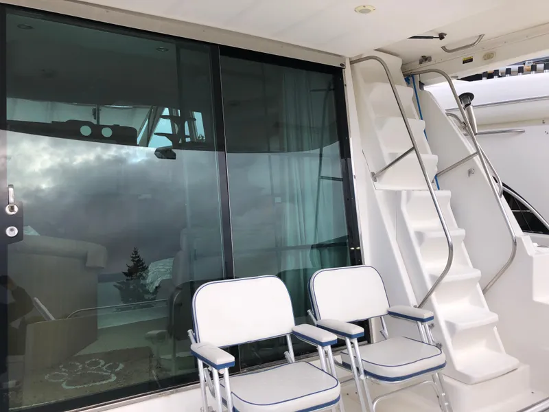 Slide: The Image of 2002 Bayliner 5288 PILOTHOUSE yacht with chairs and stairs on deck. - 5