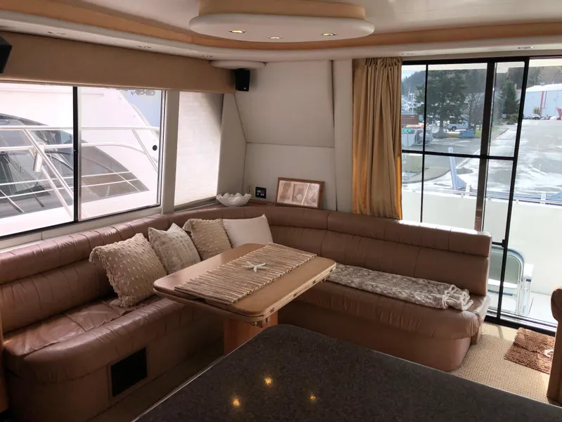 Slide: The Image of Luxurious interior of 2002 Bayliner 5288 PILOTHOUSE yacht with plush seating and large windows. - 9