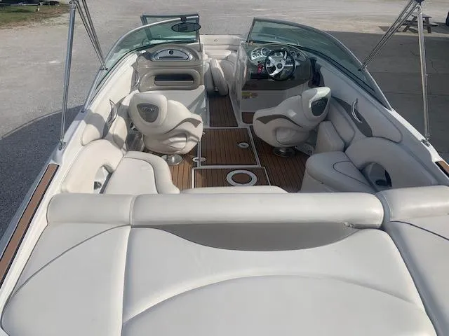 Slide: The Image of 2007 Crownline 230 LS boat interior with white seating and wood flooring. - 12