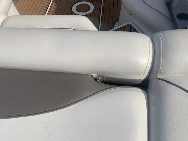 Slide: The Image of 2007 Crownline 230 LS boat seat with minor tear on white upholstery. - 13