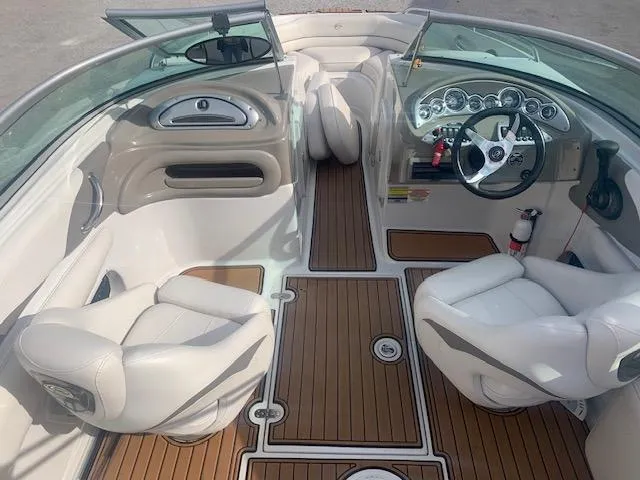 Slide: The Image of 2007 Crownline 230 LS boat interior with white seats and wood flooring. - 15