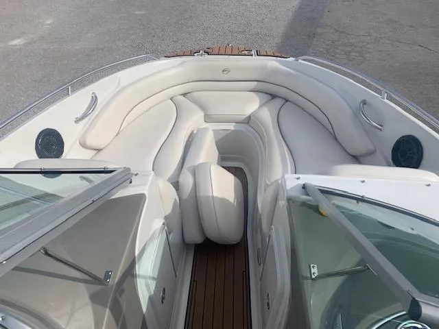 Slide: The Image of 2007 Crownline 230 LS boat interior with white seating and wood accents. - 16