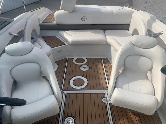Slide: The Image of 2007 Crownline 230 LS boat interior with white seating and wood flooring. - 21