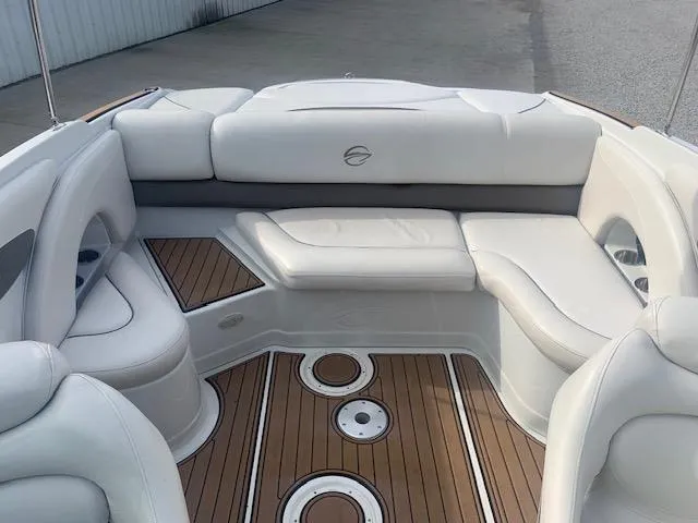 Slide: The Image of 2007 Crownline 230 LS boat interior with white seating and wood flooring. - 22