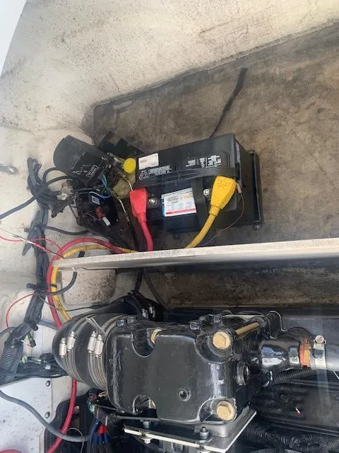 Slide: The Image of 2007 Crownline 230 LS boat engine compartment with battery and wiring. - 27