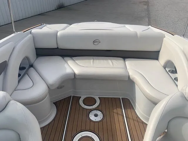 Slide: The Image of 2007 Crownline 230 LS boat interior with white seating and wood flooring. - 30