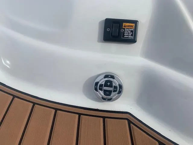 Slide: The Image of Crownline 230 LS 2007 boat control panel with warning label and teak flooring. - 31