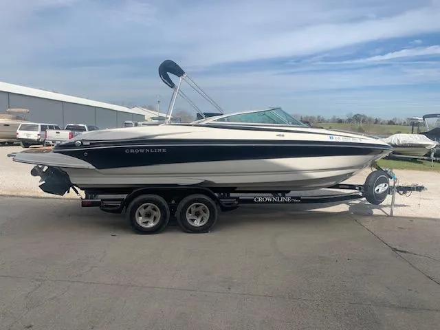 Slide: The Image of 2007 Crownline 230 LS boat on trailer, parked outdoors under a clear sky. - 34