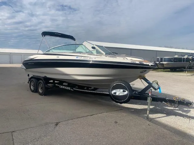 Slide: The Image of 2007 Crownline 230 LS boat on trailer, parked outdoors under a cloudy sky. - 35