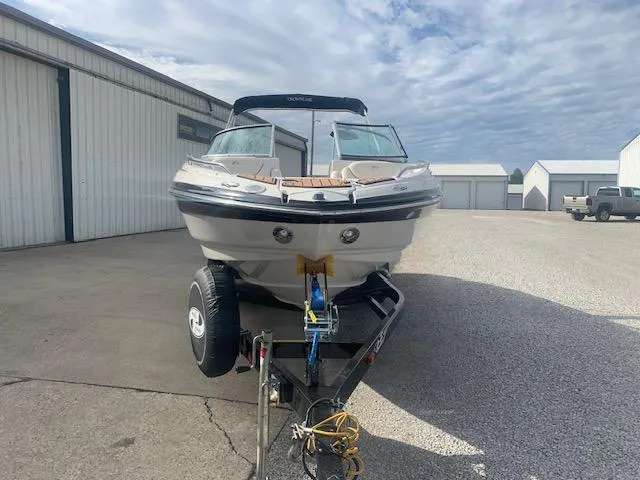 Slide: The Image of 2007 Crownline 230 LS boat on trailer, parked outdoors near storage buildings. - 36