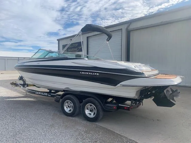 Slide: The Image of 2007 Crownline 230 LS boat on trailer, parked near a marine facility. - 39