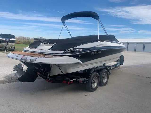 Slide: The Image of 2007 Crownline 230 LS boat on trailer, black and white design, parked outdoors. - 6