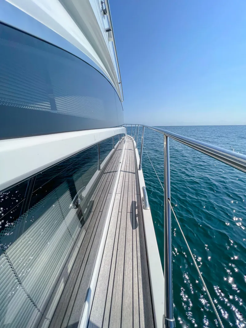 Slide: The Image of Side view of 2013 Princess 60 yacht on open sea under clear blue sky. - 22