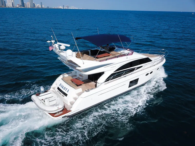 Slide: The Image of Luxurious 2013 Princess 60 yacht cruising on open sea with city skyline backdrop. - 3