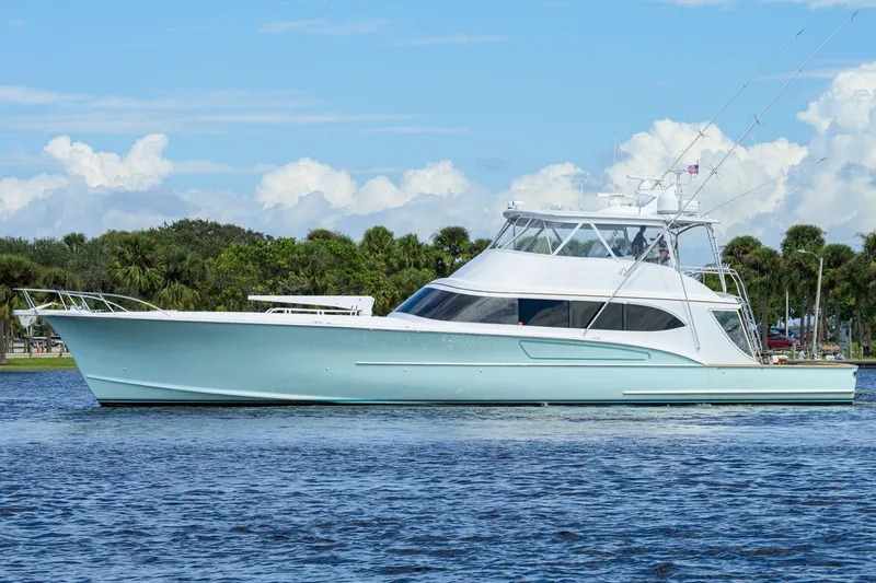 Slide: The Image of 2011 Paul Mann Custom 81 Convertible yacht on calm water, clear sky background. - 1