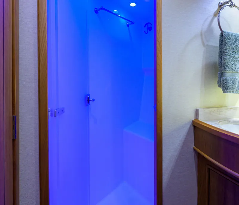 Slide: The Image of Luxurious blue-lit shower in 2011 Paul Mann Custom 81 Convertible yacht bathroom. - 21